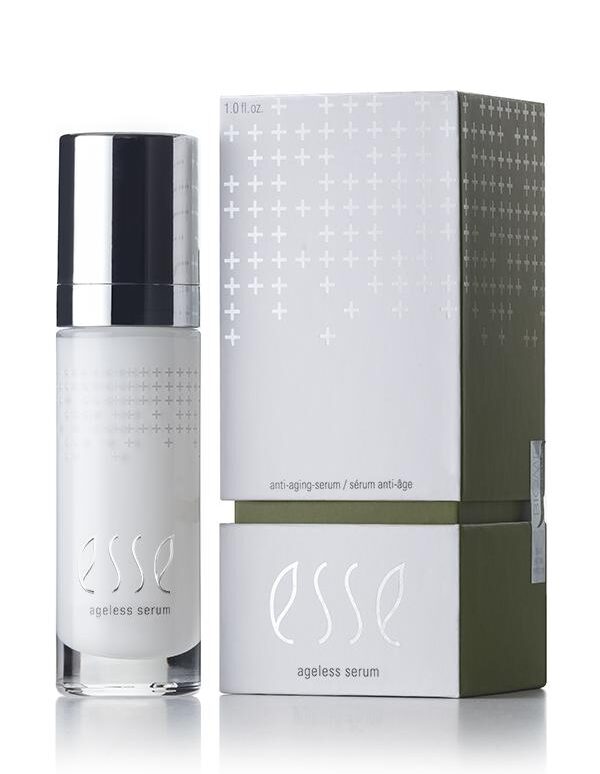 A minimalist-designed product photo featuring a white and silver bottle of Esse Ageless Serum next to its corresponding packaging box. The box is primarily white with plus sign graphics and a green section at the bottom. The text reads "anti-aging serum" and "Esse Ageless Serum.