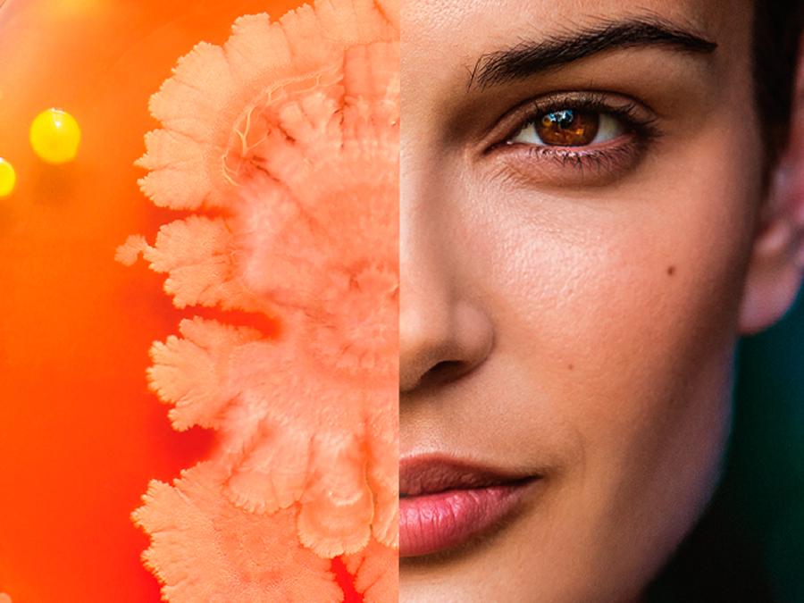A composite image showing half of a person's face on the right side and a close-up of a coralline structure with a vibrant orange hue on the left side, blending art and human expression.