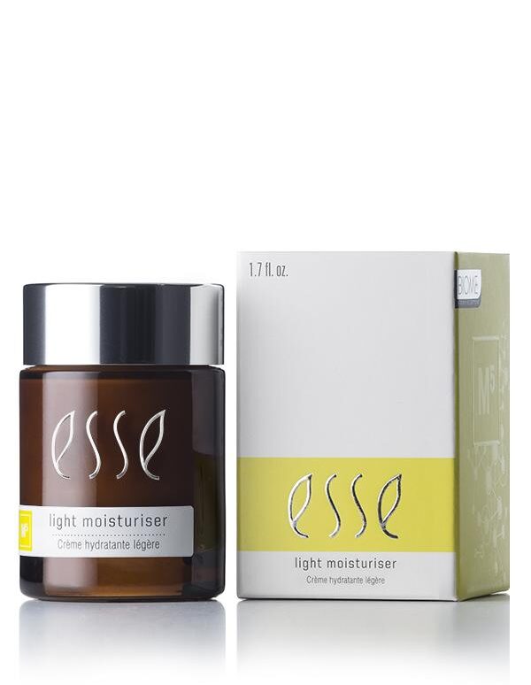 A 1.7 fl. oz. jar of Esse Light Moisturiser is showcased beside its matching white and yellow packaging. The jar features a dark amber hue, a black cap, and the product name "Esse Light Moisturiser" is prominently displayed in white text on both the jar and the box.