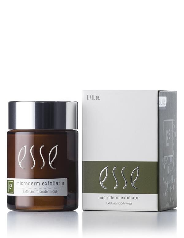 A brown jar of Esse Microderm Exfoliator with a black lid sits beside its packaging. The box is white with grey and green accents, showcasing the same product name and branding. Both the jar and the box have a glossy finish that reflects the light.