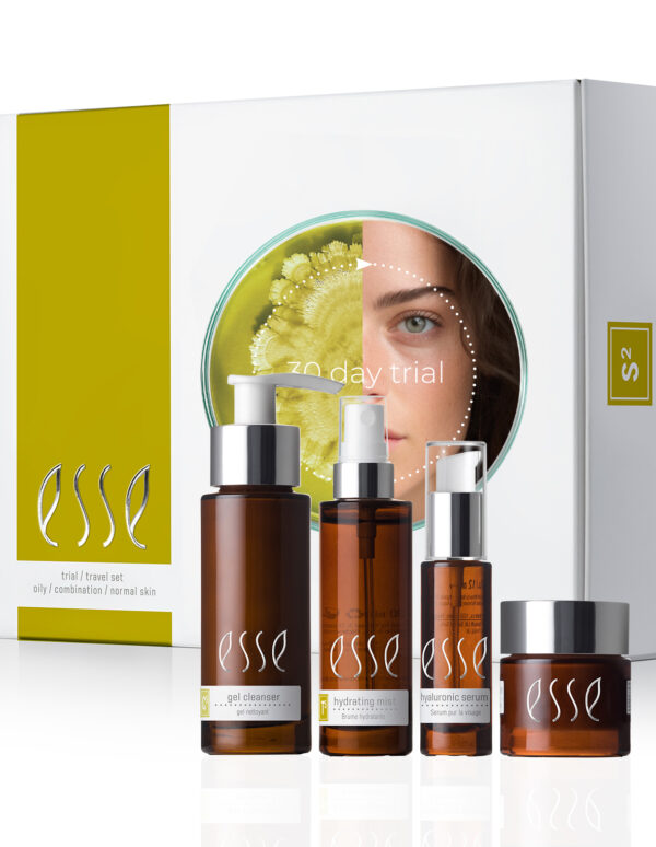 The Esse Oily / Combination / Normal Trial / Travel Set features four brown bottles with white text and pumps, housed in a white and green box displaying an image of a woman partially obscured behind a leaf. This skincare set includes a gel cleanser, hydrating serum, and hyaluronic serum.