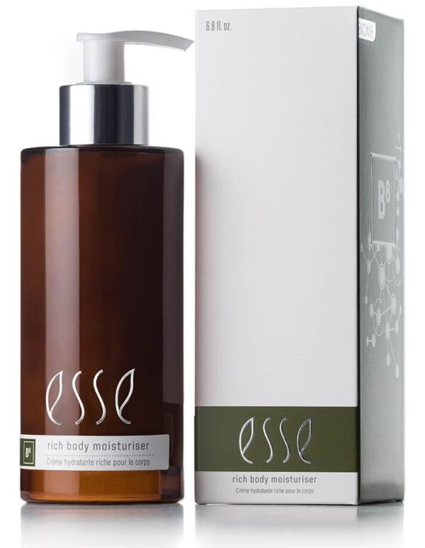 A bottle of Esse Rich Body Moisturiser, made from dark amber glass and equipped with a pump dispenser, is positioned beside its packaging. The predominantly white box with green accents showcases detailed product information and branding. Both the bottle and the box prominently feature the Esse logo.