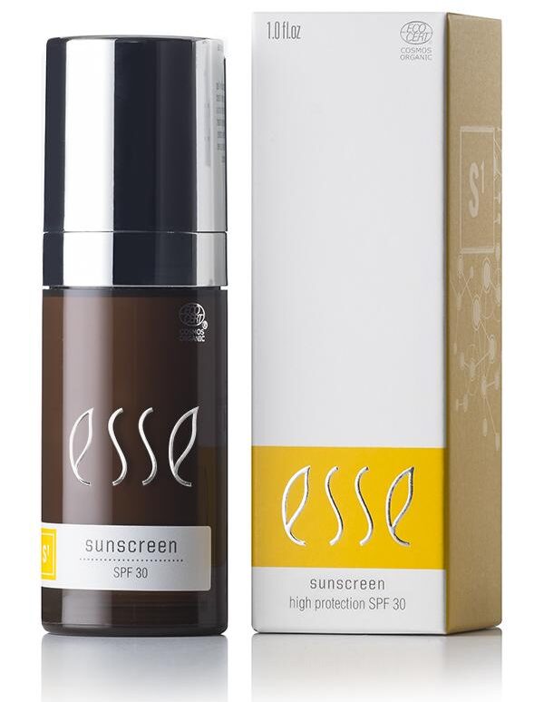 An Esse Sunscreen bottle with SPF 30 stands next to its box packaging. The brown bottle, featuring a black cap, showcases the Esse logo and product details in white. The light brown box includes yellow and white labels that display the same product information.