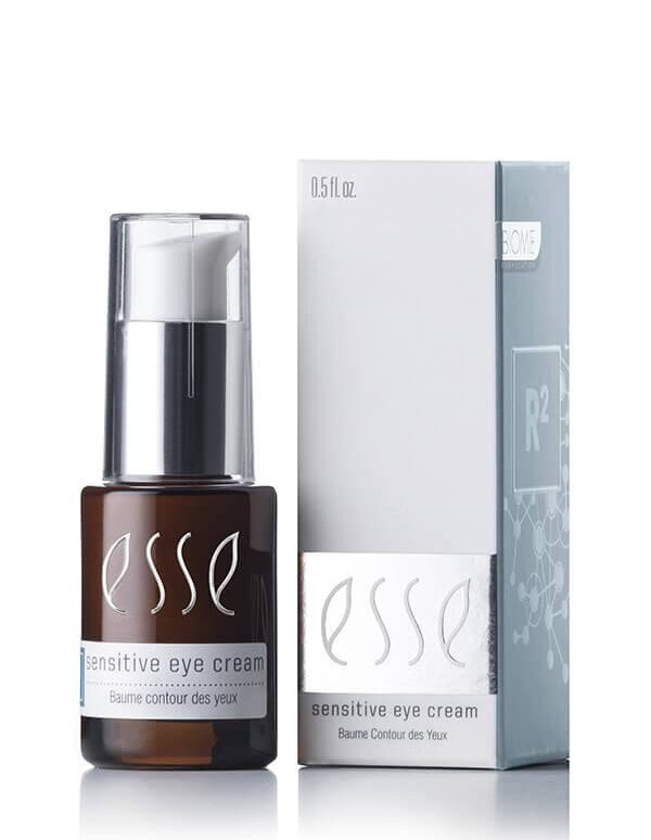 The image features a small bottle of Esse Sensitive Eye Cream beside its box packaging. The dark amber bottle, adorned with white text, includes a convenient pump dispenser. The light grey packaging displays matching white text and prominently shows the product name, Esse Sensitive Eye Cream.
